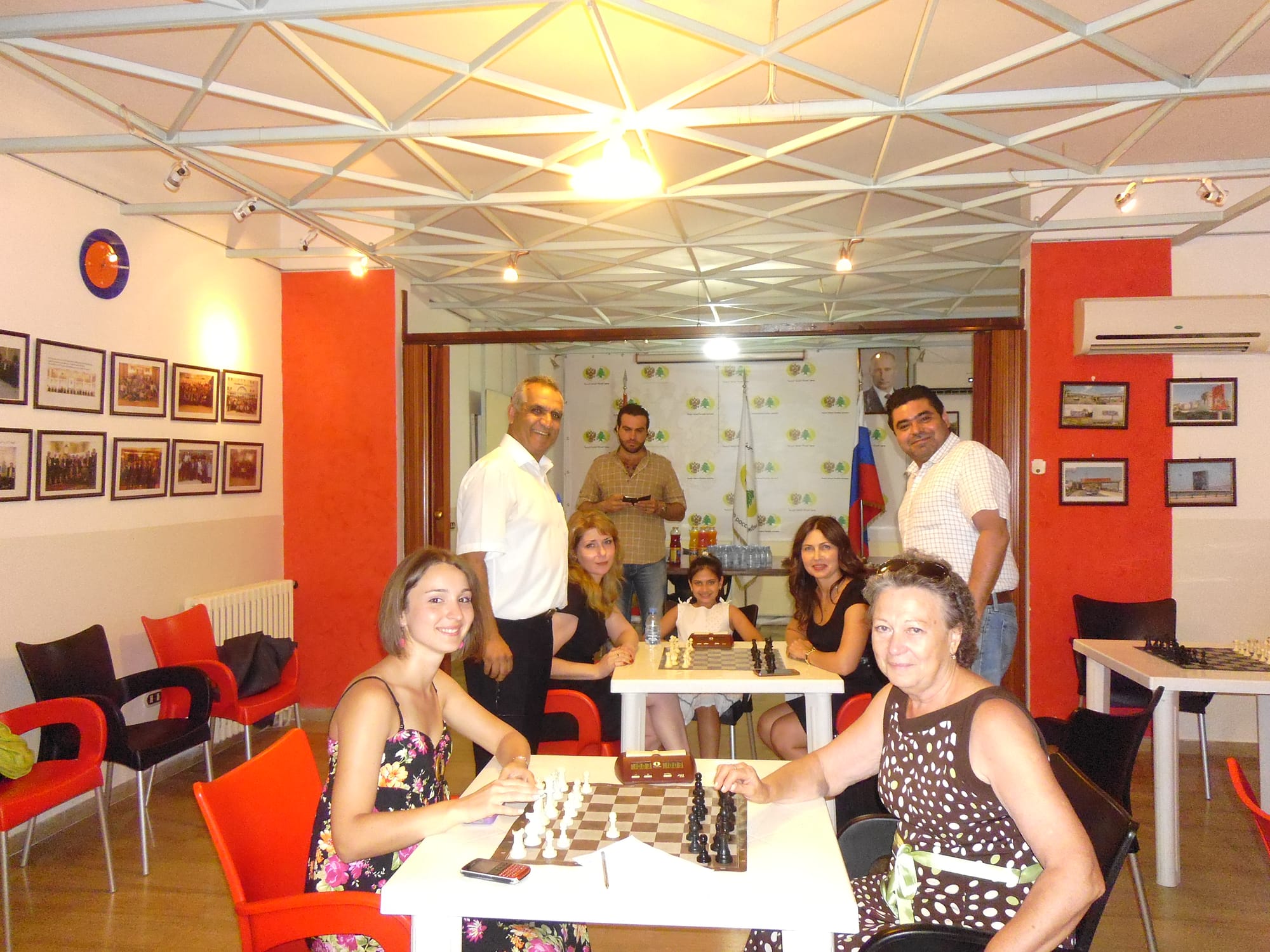 Members smile from their boards in the bright club playing room