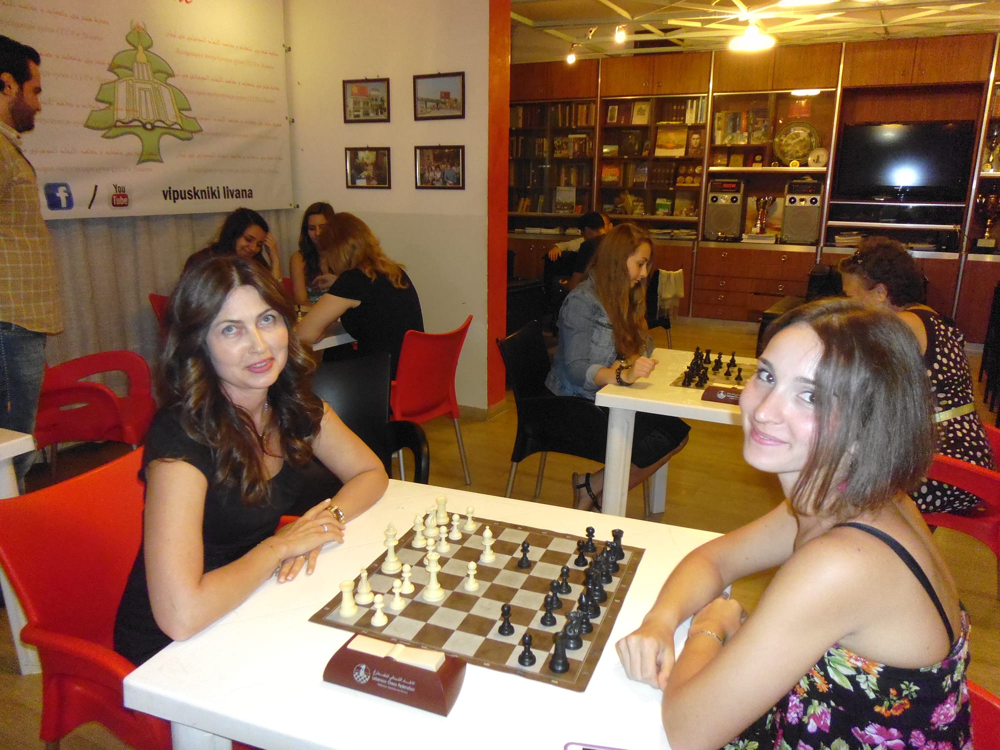 Two members pause their game to smile at the camera