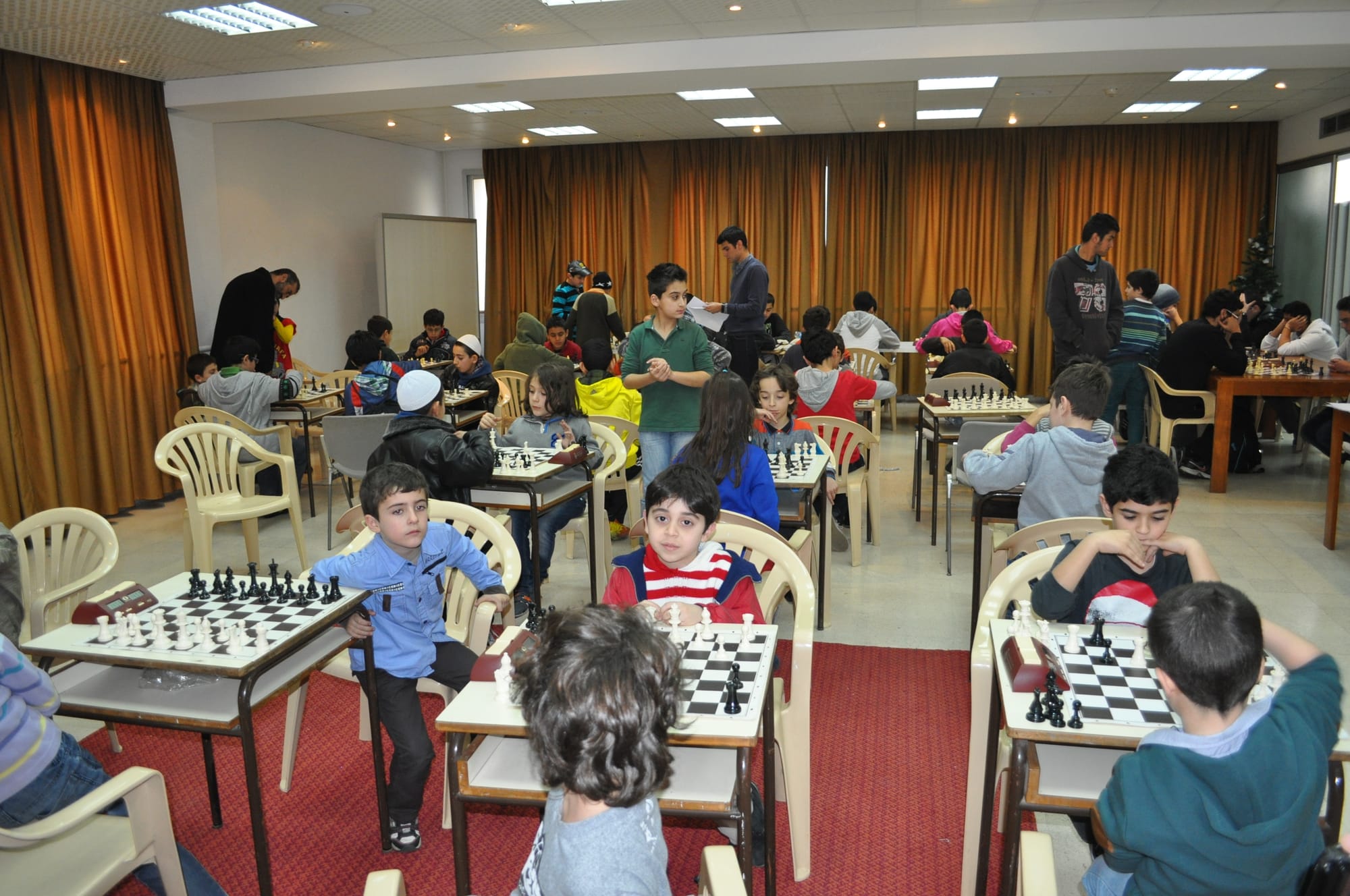 A crowded junior tournament in full swing across many boards
