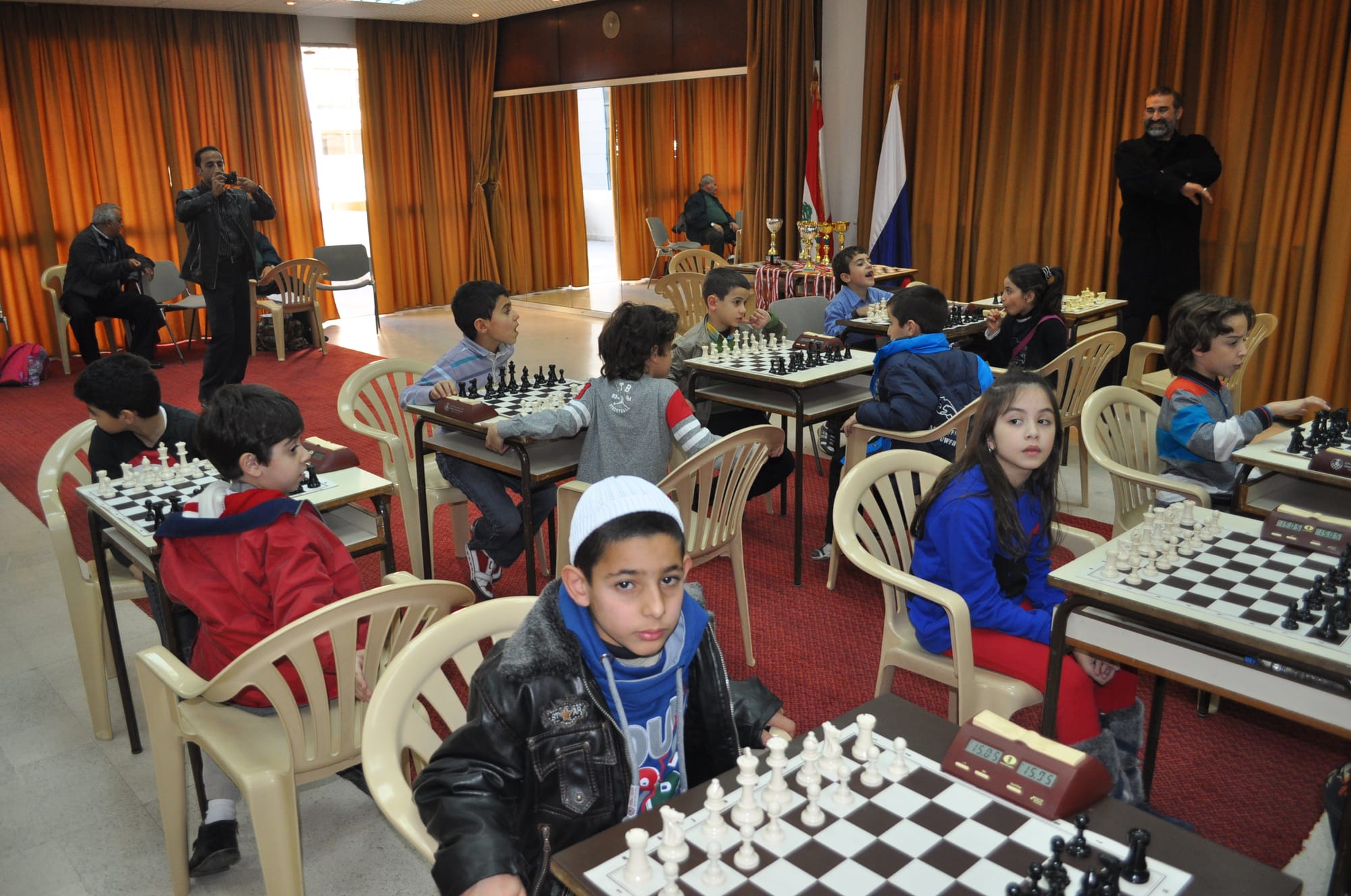 Young competitors at their boards with trophies waiting at the back
