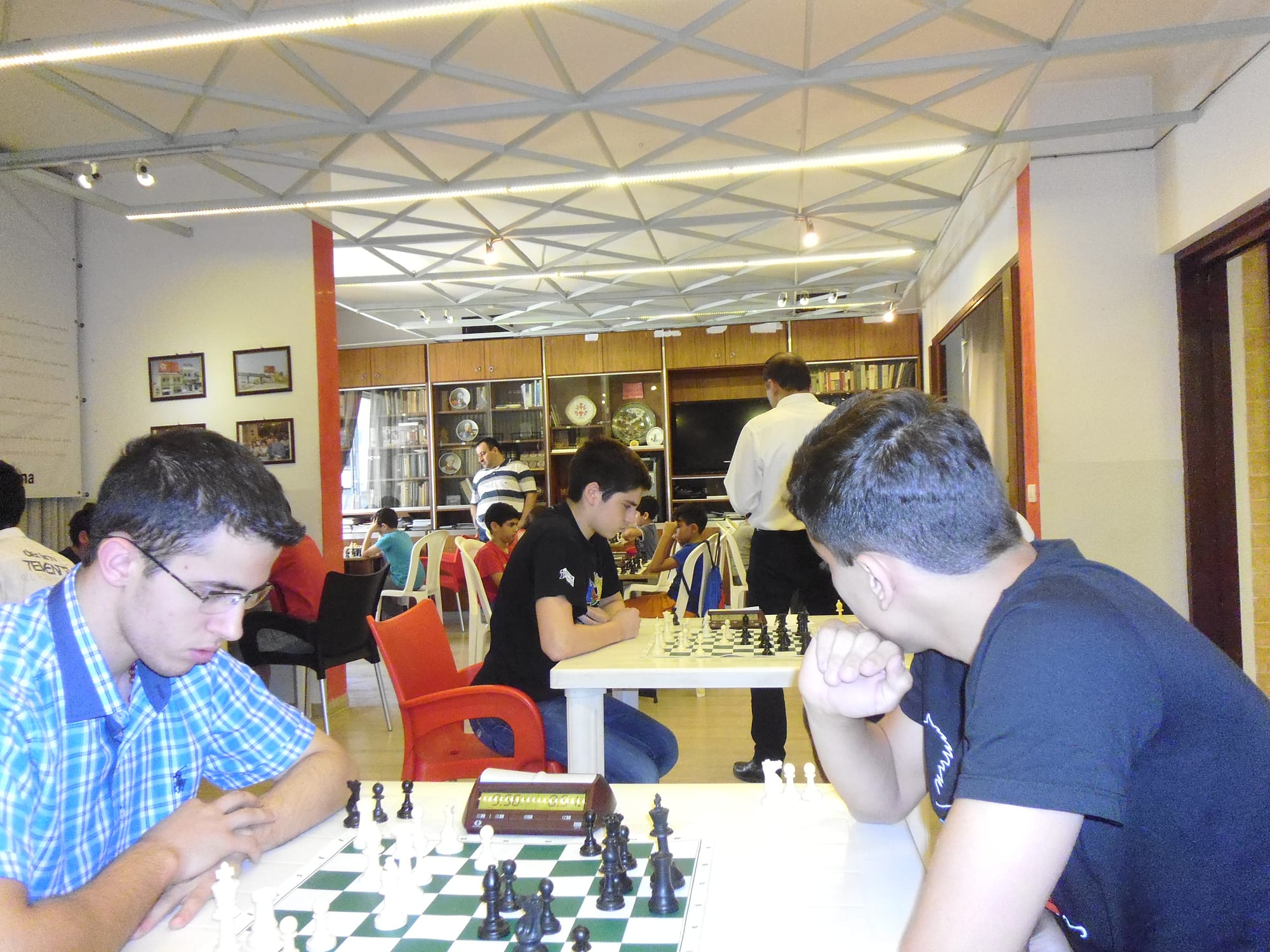 Teenage players concentrate during a junior tournament round