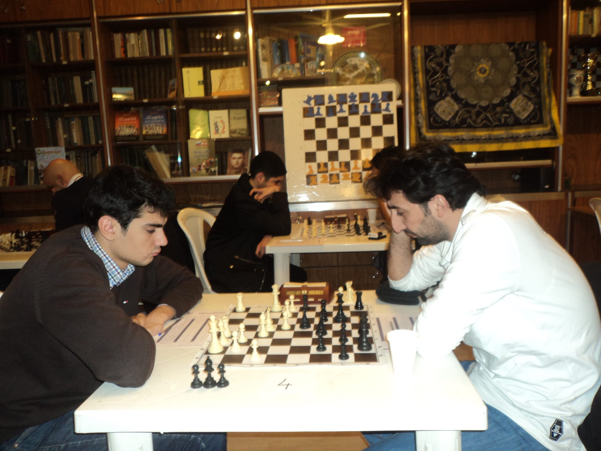 Two members deep in thought during a club tournament game