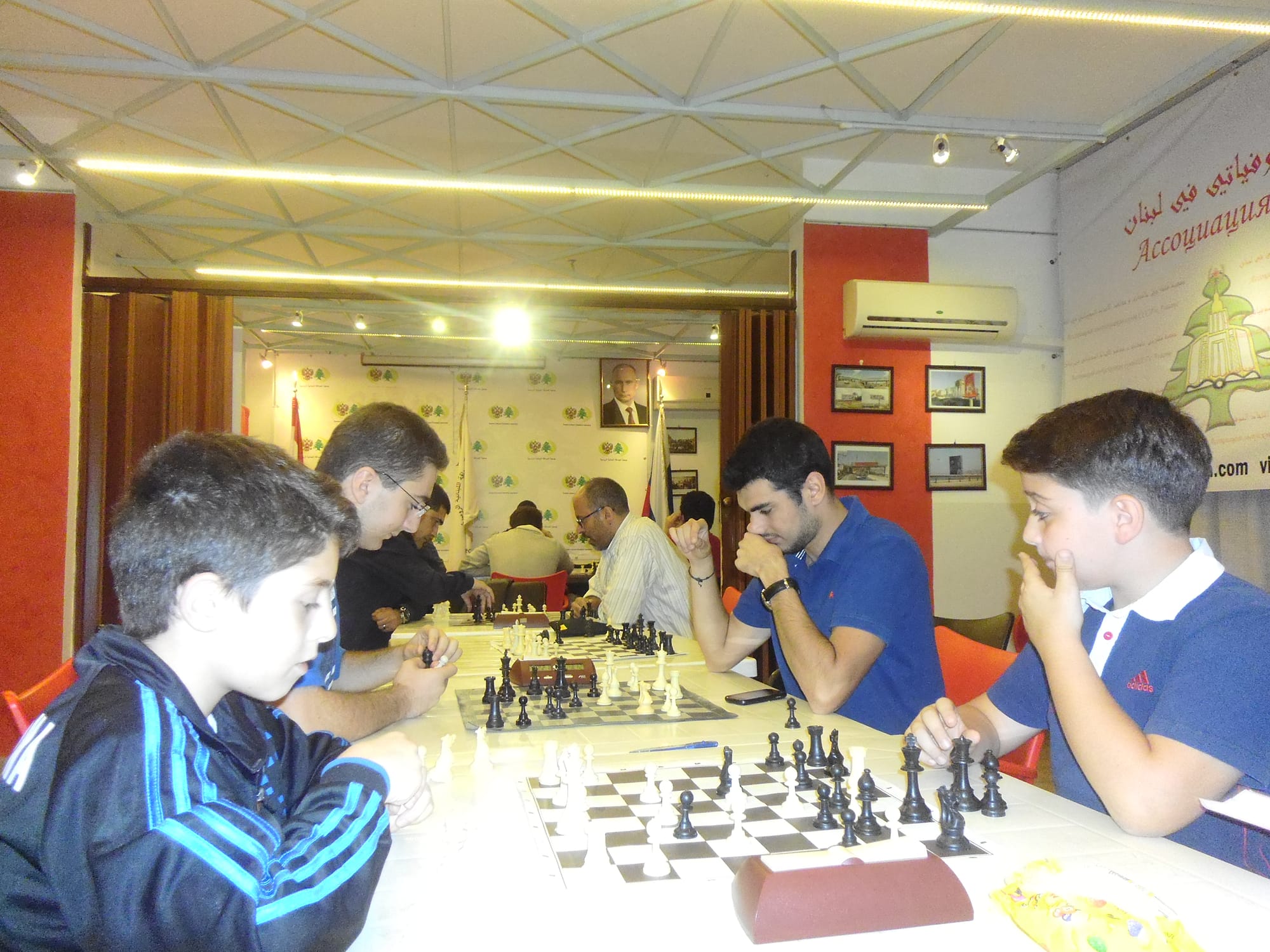 Players concentrating along a row of boards during a tournament round