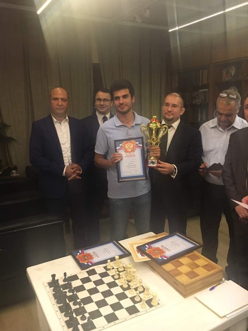 Champion holds his trophy and diploma after the prize-giving